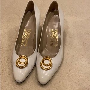 White Ferragamo shoes with gold buckle